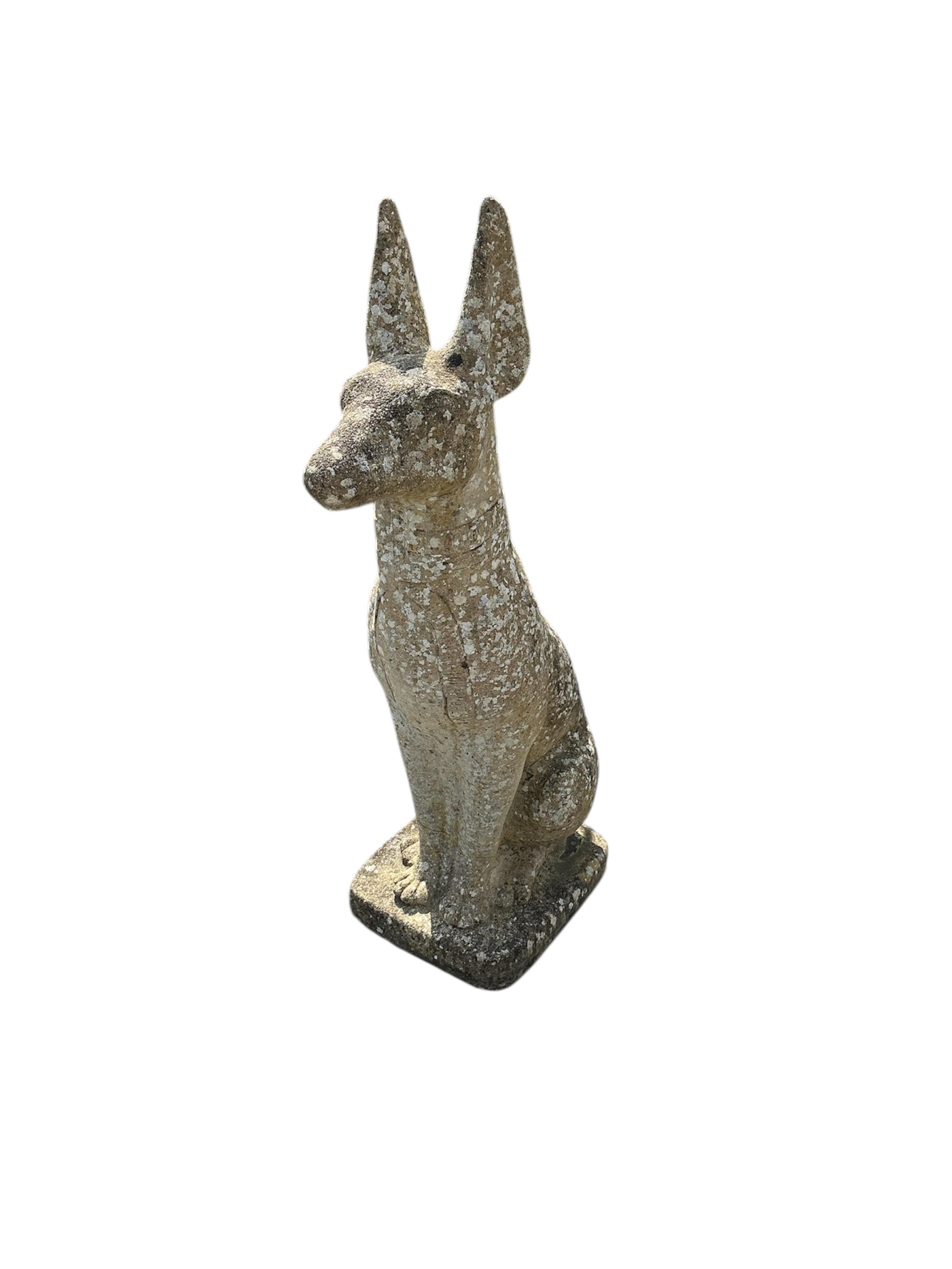 A reconstituted stone seated Anubis garden ornament, height 86cm
